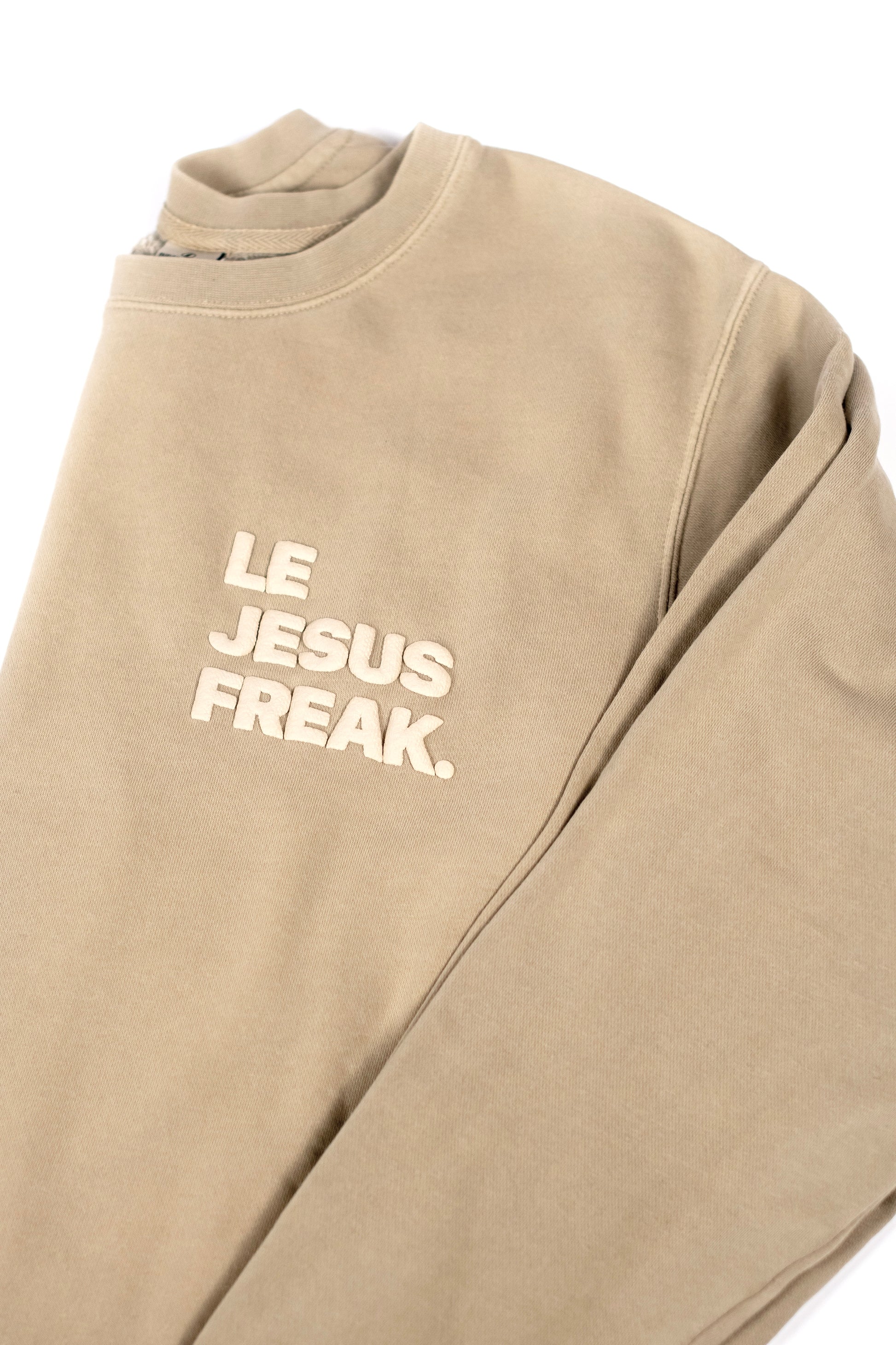Beige sweatshirt with 'LE JESUS FREAK' text on a white background