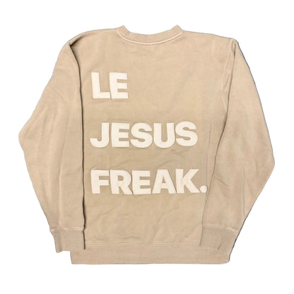 Beige sweatshirt with 'LE JESUS FREAK.' text on the back against a white background